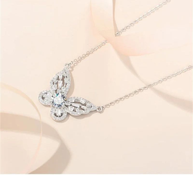 Silver butterfly-shaped necklace on a soft beige background