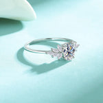 Silver ring with a diamond on a light blue background