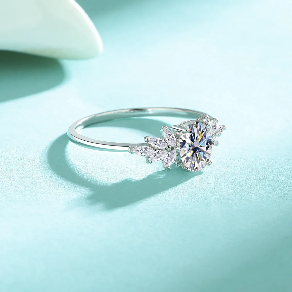 Silver ring with a diamond on a light blue background