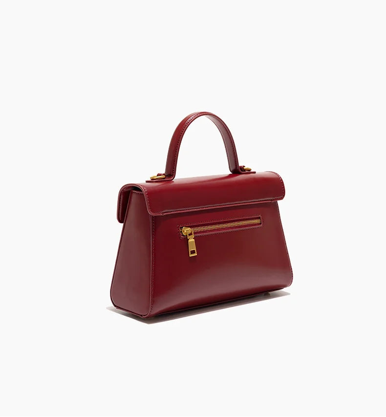 Red handbag with gold zipper on a white background