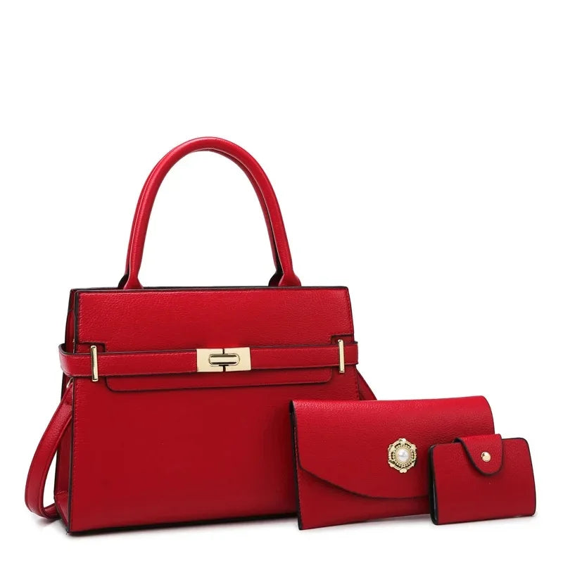 Red handbag with matching wallet and cardholder on a white background