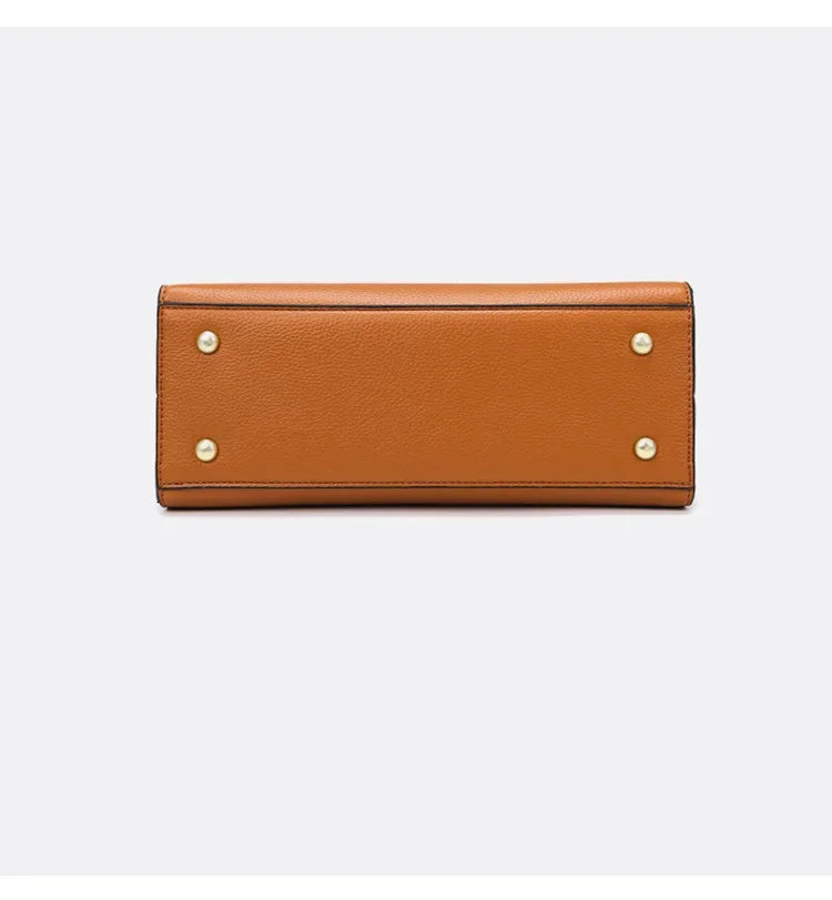Brown leather wallet with gold accents on a light gray background