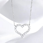 Heart-shaped diamond necklace on a white background