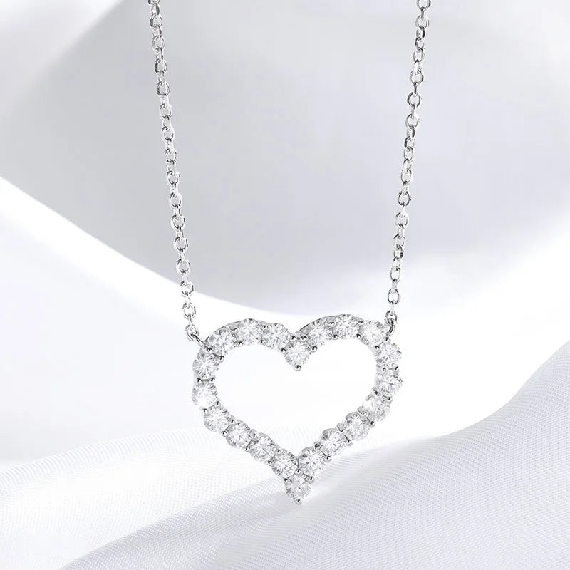 Heart-shaped diamond necklace on a white background