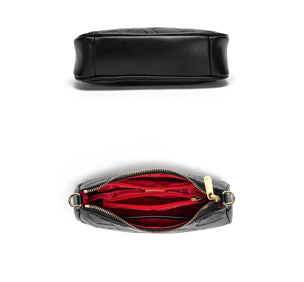 Black handbag with open view showing red interior on a white background