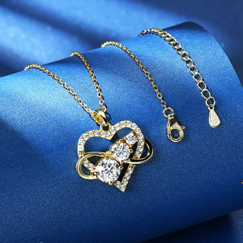 Gold necklace with a heart-shaped pendant on a blue satin background