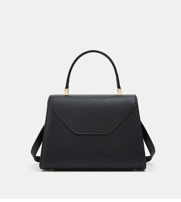 Black handbag with gold accents on a white background