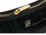 Black handbag with gold zipper and logo on a white background