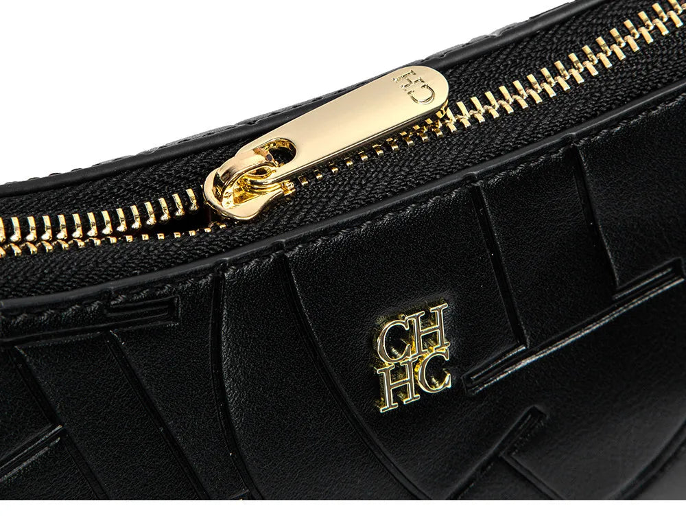Black handbag with gold zipper and logo on a white background