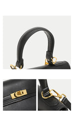 Black handbag with gold hardware on a light gray background