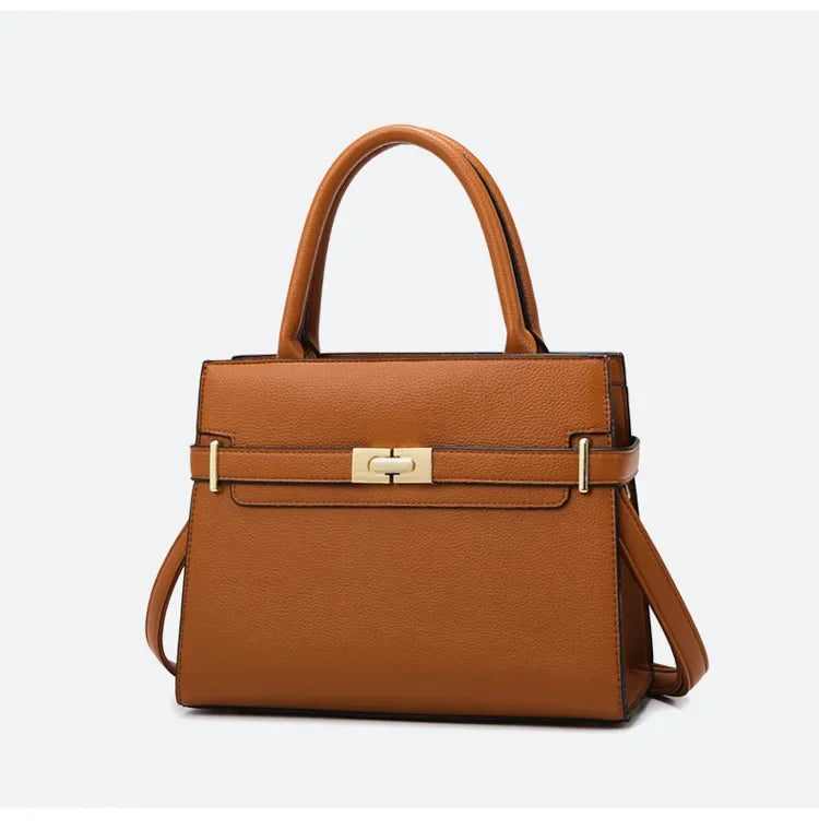 Brown handbag with gold hardware on a light gray background
