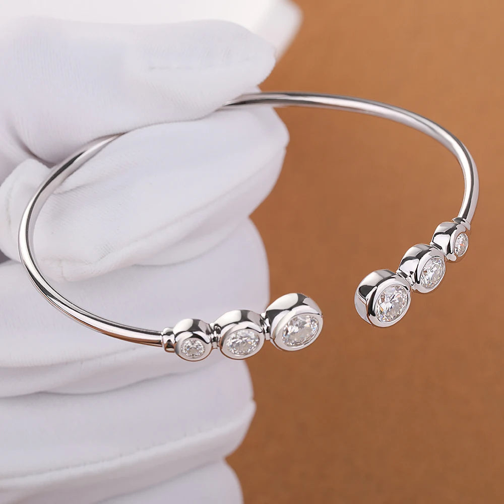 Silver bracelet with embedded stones on a white surface