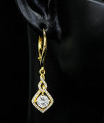 Gold earring with a diamond on a black background