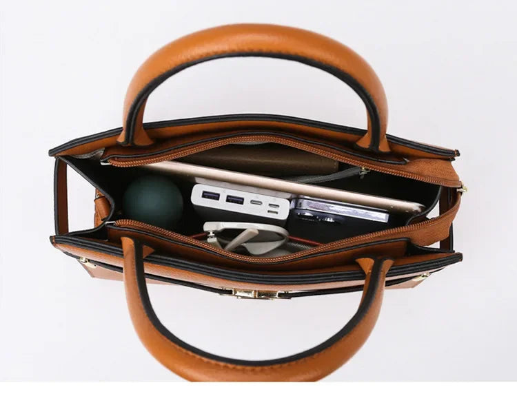 Brown leather handbag with interior compartments on a white background