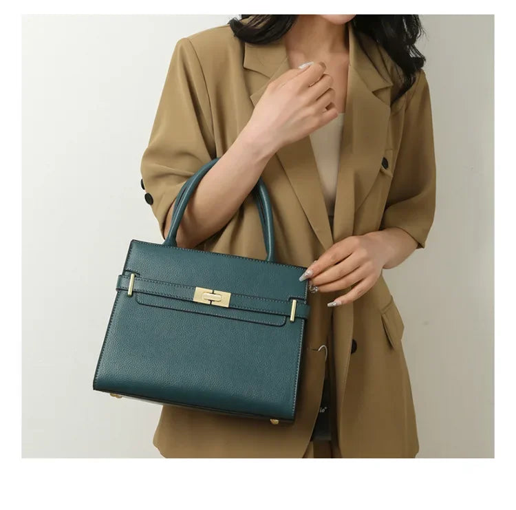 Person holding a teal handbag with a neutral background