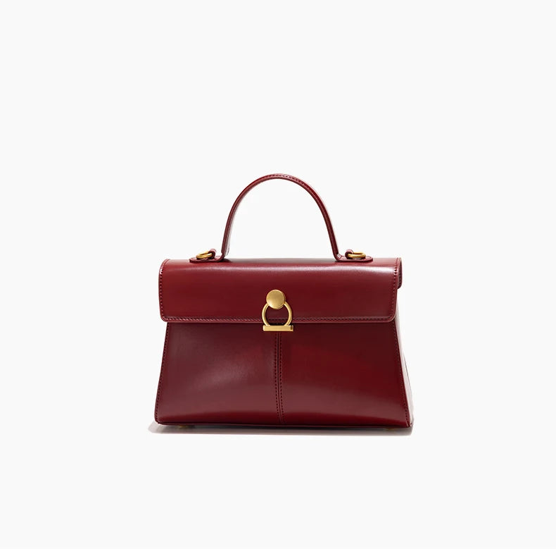 Red handbag with gold accents on a white background