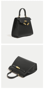 Black handbag with gold accents on a white background