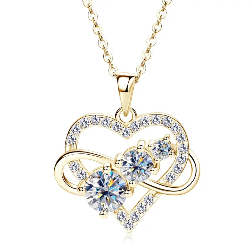 Gold heart-shaped necklace with clear gemstones on a white background