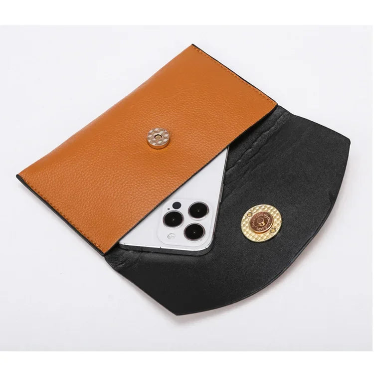Black and brown leather pouch with a phone inside on a white background