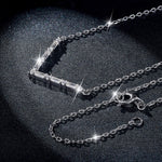 Silver necklace with a clasp on a dark background