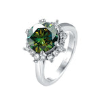 Silver ring with a green gemstone on a white background