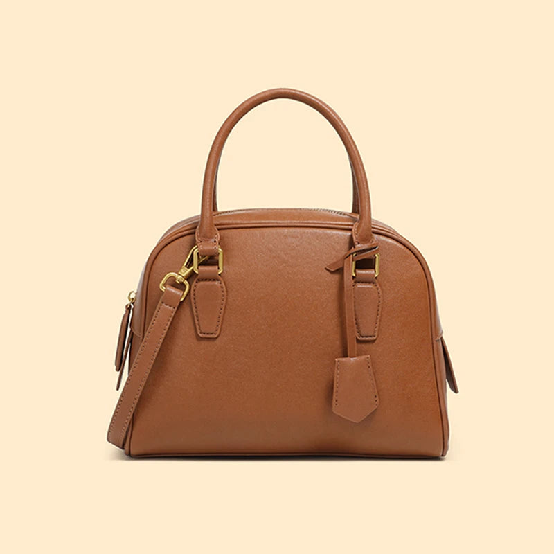 Brown handbag with a strap on a beige background