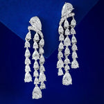 Pair of diamond chandelier earrings on a blue background