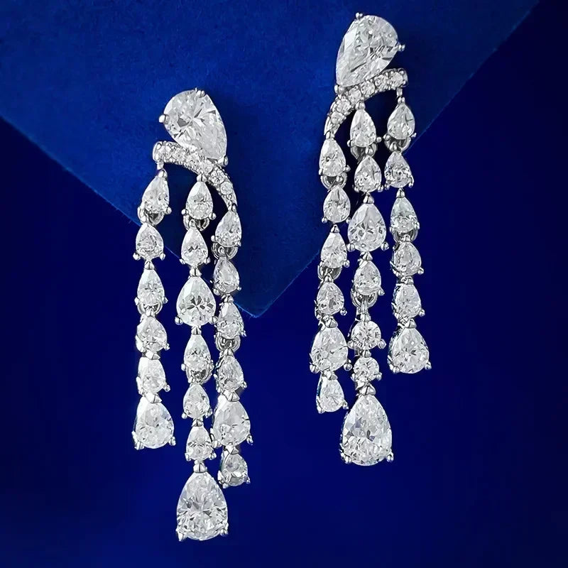 Pair of diamond chandelier earrings on a blue background
