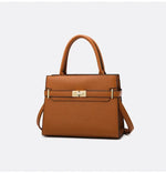 Brown handbag with gold hardware on a light gray background