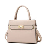 Beige handbag with gold hardware on a white background