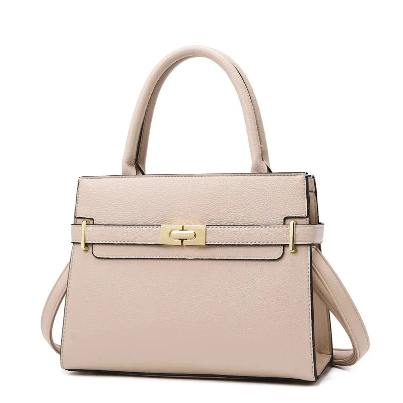 Beige handbag with gold hardware on a white background