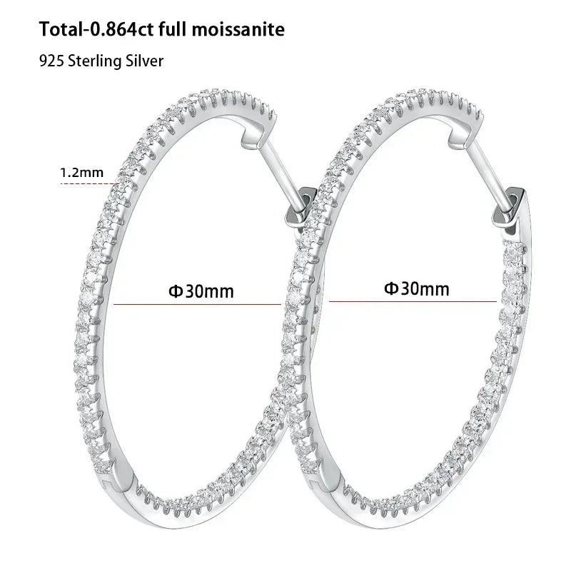 Silver hoop earrings with moissanite stones, showing dimensions and material details.