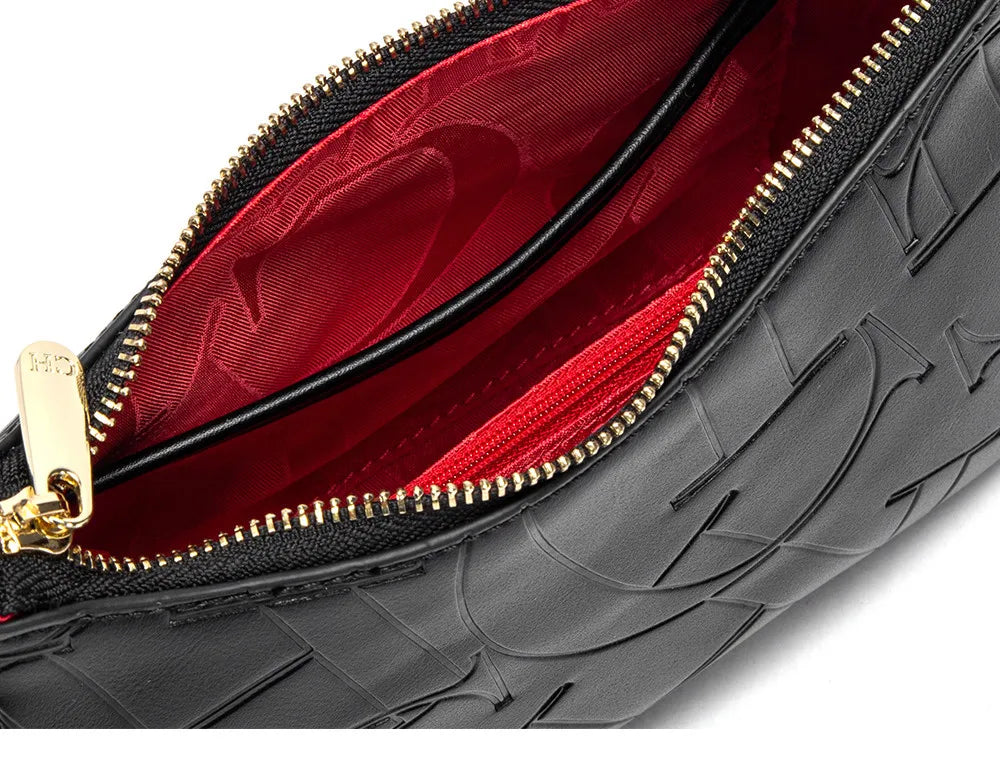 Black textured clutch bag with gold zipper and red interior