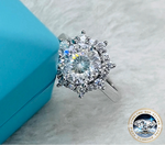 Silver ring with a large diamond on a textured surface, featuring the brand 'Joyce Jelly'.