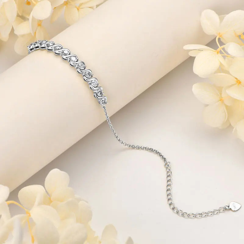Silver bracelet on a light background with decorative flowers