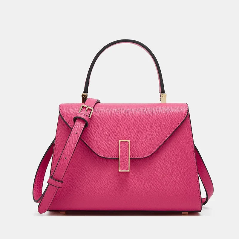 Pink handbag with a gold clasp on a light gray background