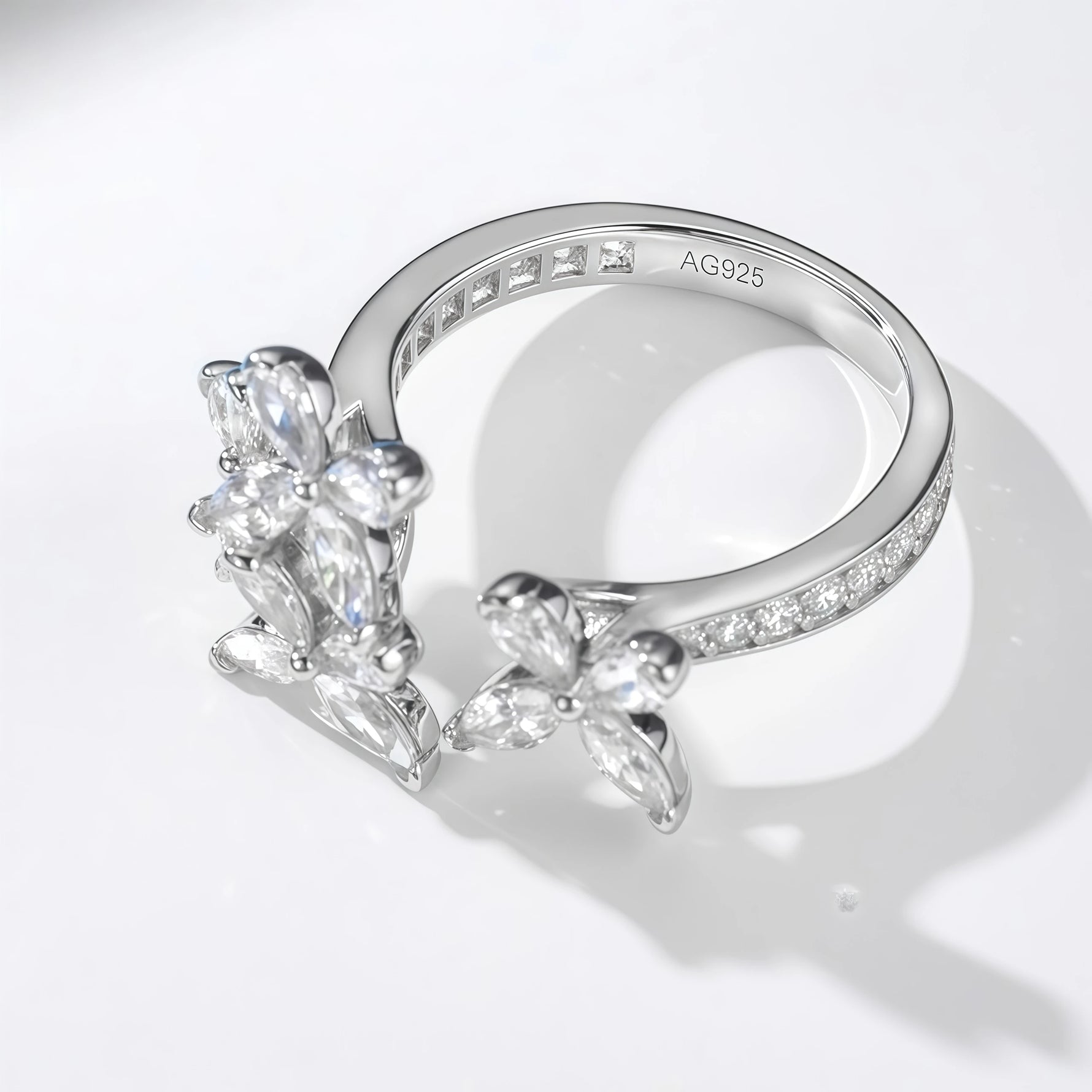 Silver ring with butterfly design on a white background