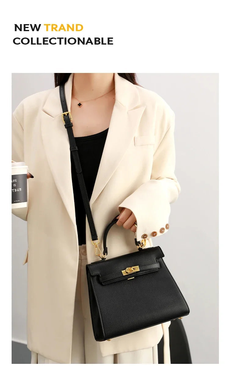Person holding a black handbag with a neutral background