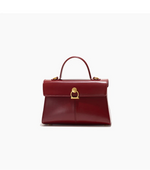 Red handbag with gold clasp on a white background