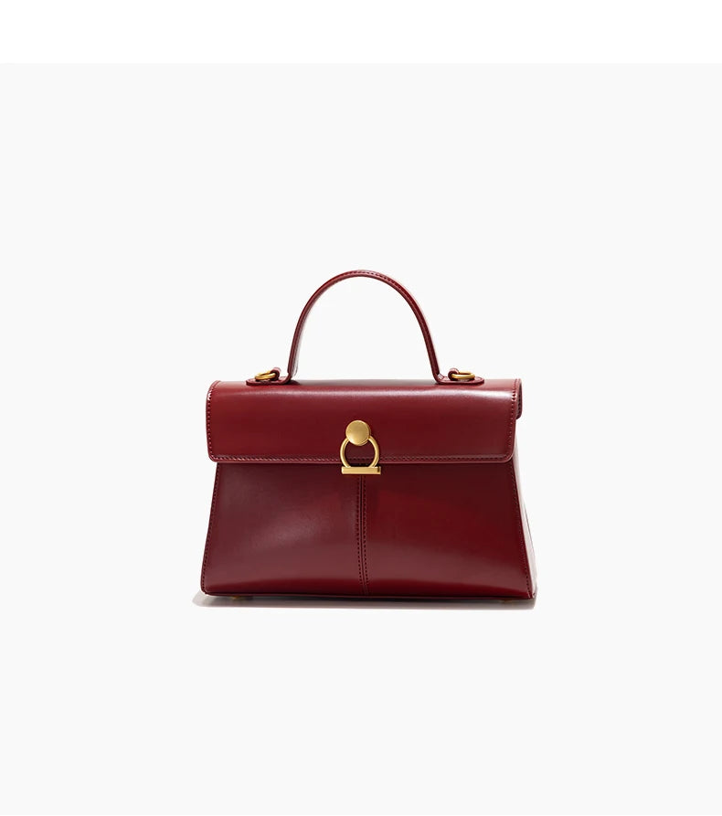 Red handbag with gold clasp on a white background