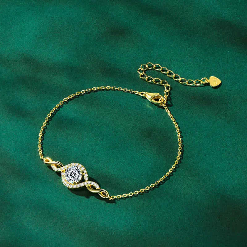 Gold bracelet with a diamond on a green background