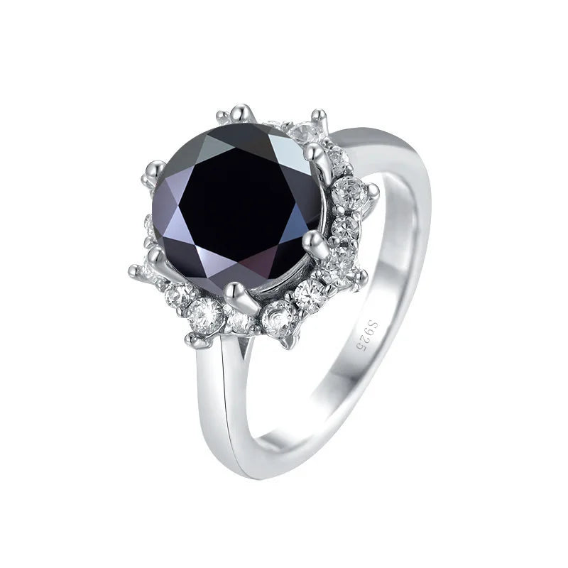 Silver ring with a black gemstone and diamond accents on a white background
