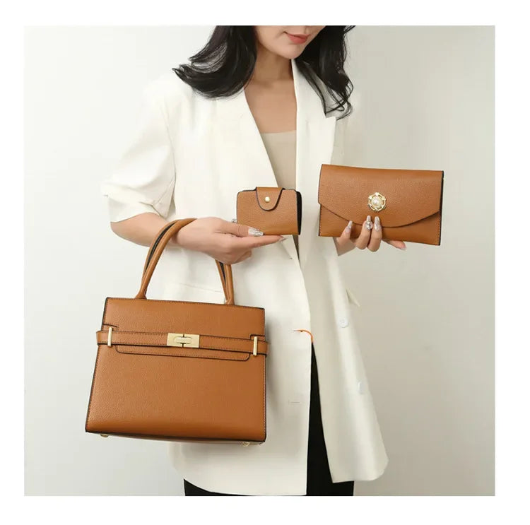 Woman holding two brown handbags against a plain background