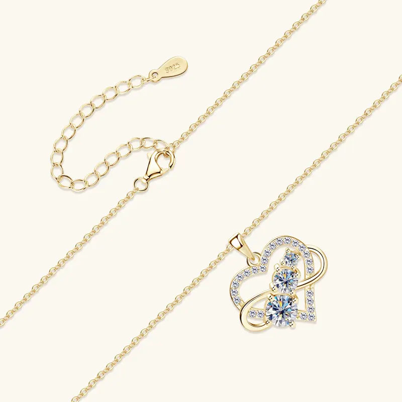 Gold necklace with a heart-shaped pendant on a white background
