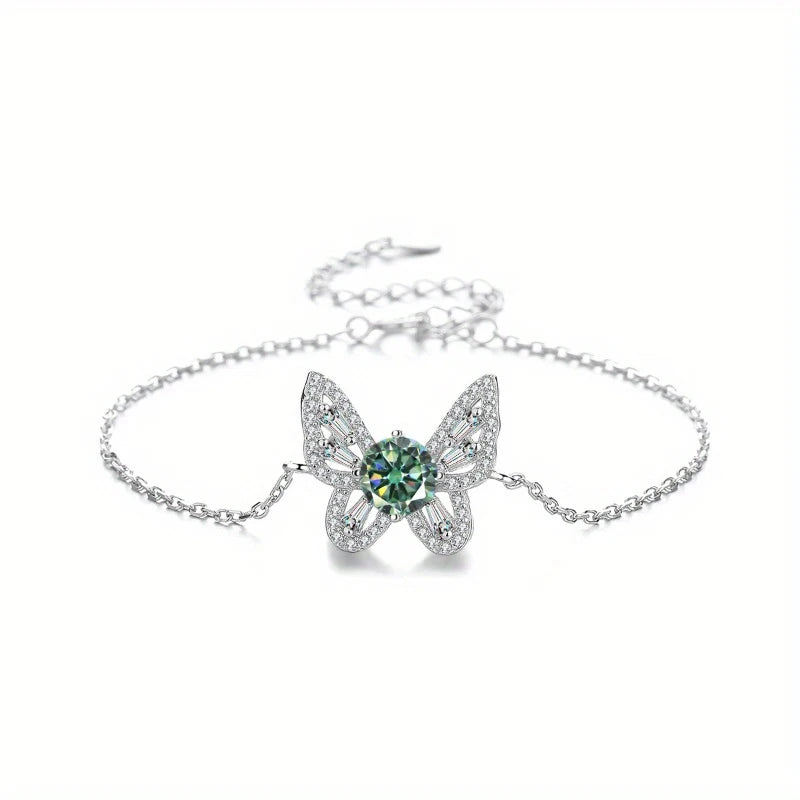 Butterfly-shaped bracelet with green gemstone on a white background