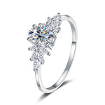 Silver ring with a large central diamond and smaller diamonds on a white background