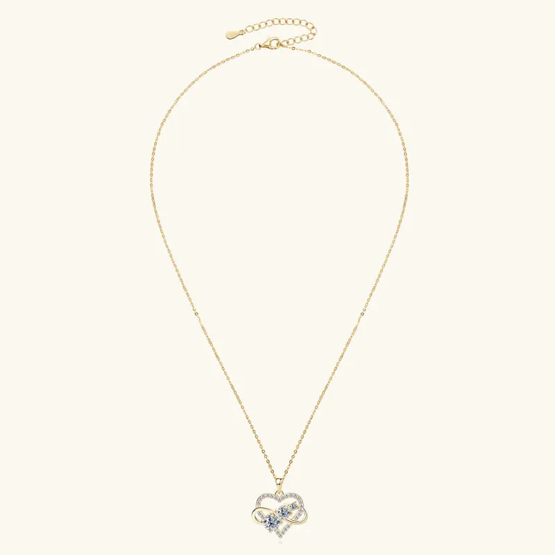 Gold necklace with a heart-shaped pendant on a white background