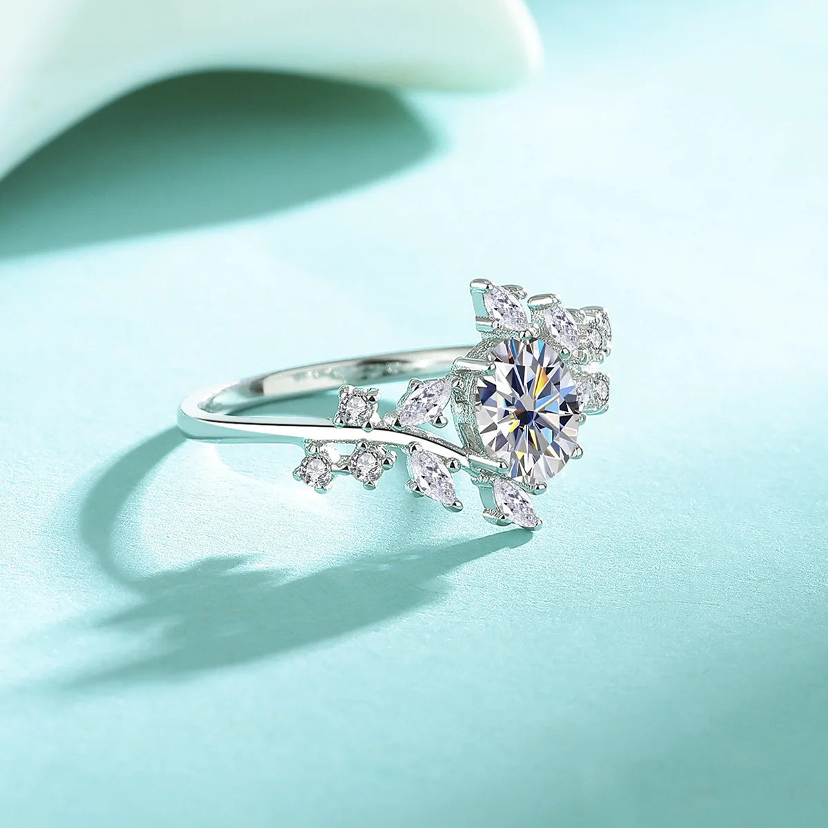 Silver ring with diamond on a light blue background