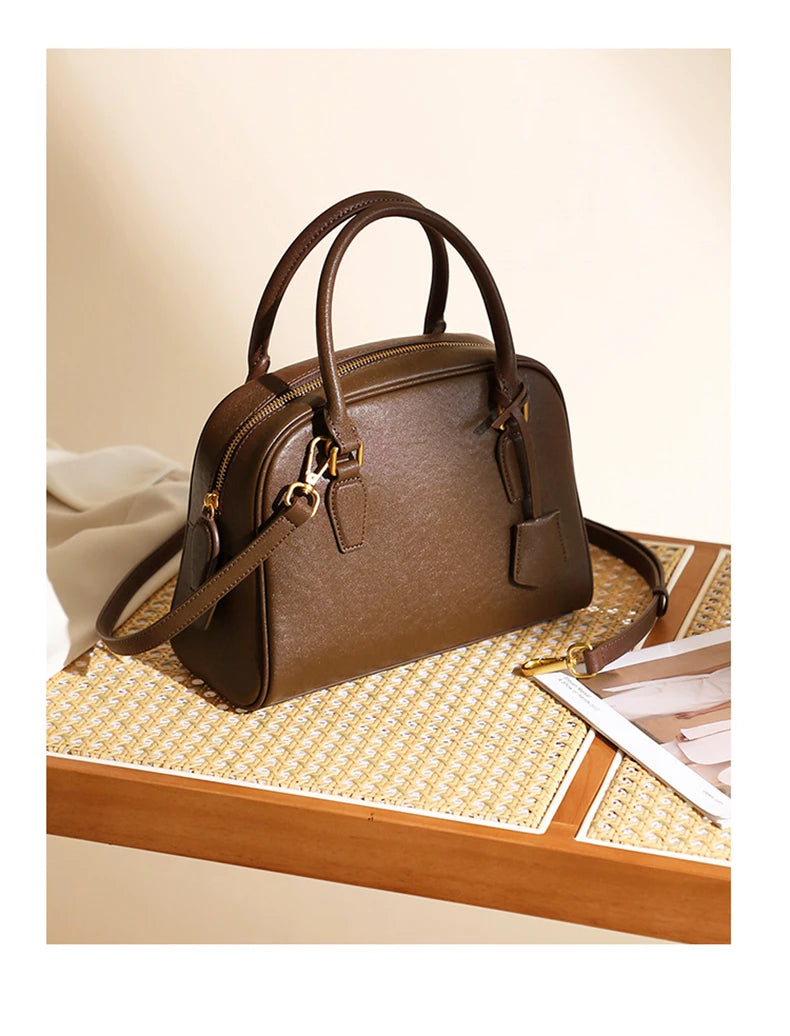 Brown handbag on a wooden surface with a light background
