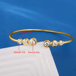 Gold bracelet with diamond measurements on a blue background